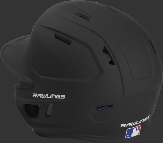 Back left view of a matte black MACHEXTL MACH series batting helmet with air vents