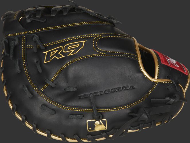 Black back of a R9 series 1st base mitt with gold stitching and MLB logo on the pinkie - SKU: R9FM18BG
