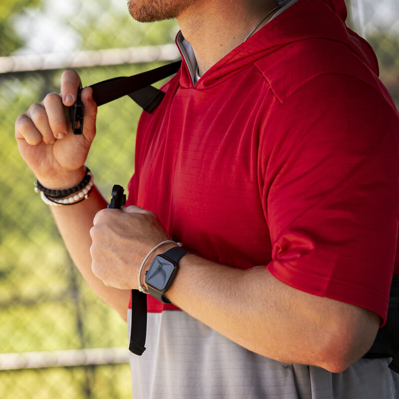 A player strapping a black Rawlings sling bag over his shoulder - SKU: RSLINGBG