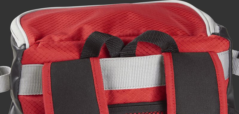 Back carry strap with the hook tucked in its compartment on a scarlet VELOBK Rawlings Velo backpack