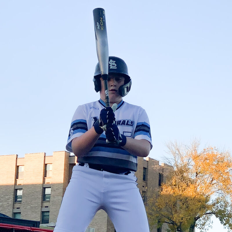 A player holding a white Icon USA bat in front of him - SKU: RUS3I10