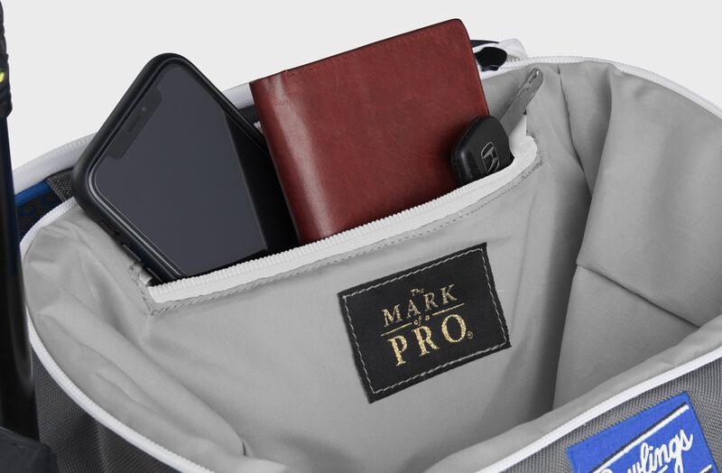 Zippered pocket in the top storage compartment of a royal Impulse backpack with a phone, wallet and keys - SKU: IMPLSE-R