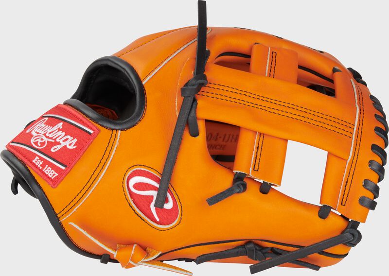 Thumb of an orange Jackson Holliday Heart of the Hide Infield Glove with a single post web