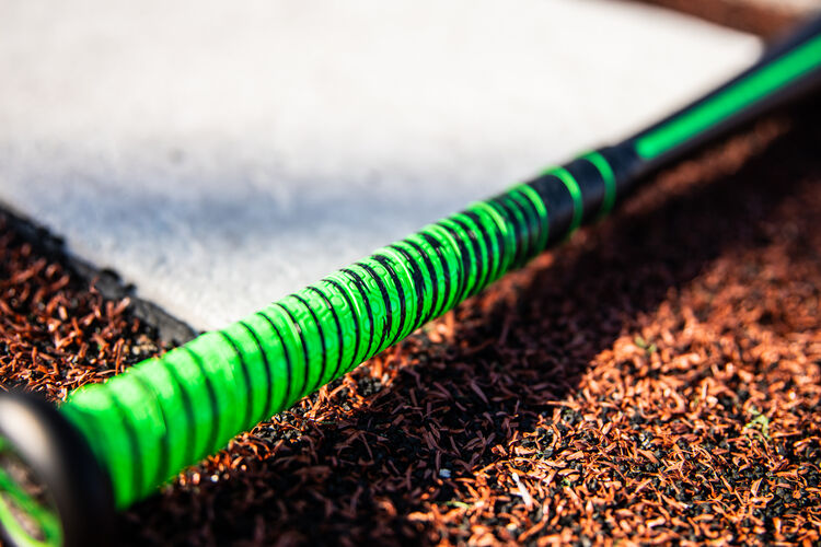 Green/black batting grip on a 2021 USSSA 5150 bat on a field next to home plate - SKU: UT1510