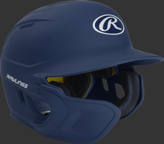 Right angle view of a matte navy MACHEXTL Mach Junior helmet with Mach EXT left hand batter face guard extension