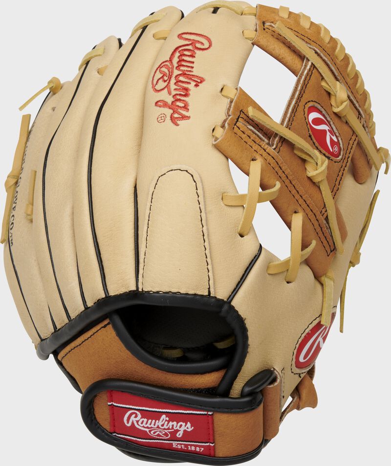 Back of a camel Sure Catch 10.5-Inch youth I-web glove with a red Rawlings patch on the Velcro wrist strap - SKU: SC105TCI loading=