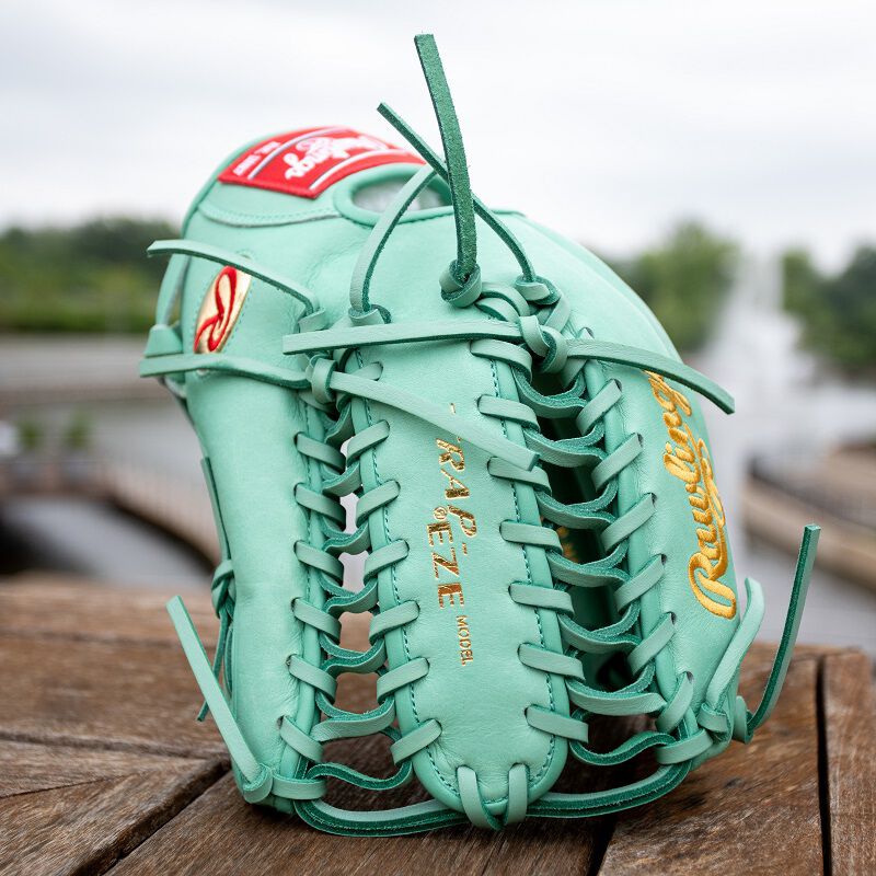 Picture of an ocean mint Harrison Bader G57 Pro Preferred glove standing on it's finger tips and web loading=