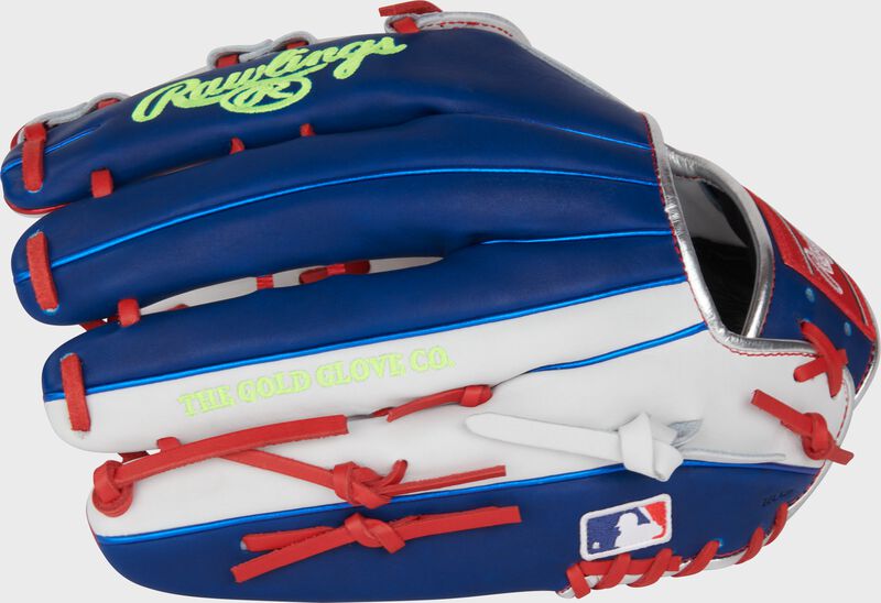 Royal blue and white back of a Heart of the Hide Luis Robert outfield glove with the MLB logo on the pinky