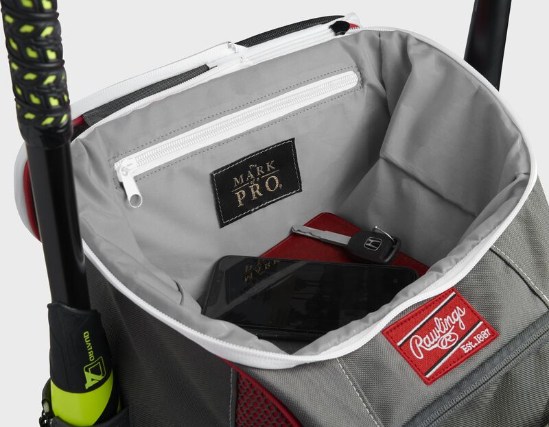 Top compartment of a scarlet Impulse bag with a phone, keys and black "The Mark of a Pro" patch - SKU: IMPLSE-S