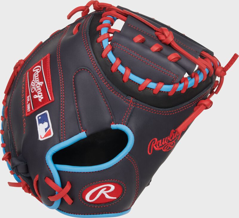 Back of a navy Rawlings NXT Series 32.5-Inch Catcher's Mitt with a red Oval-R on the wrist loading=