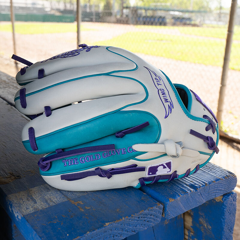 Picture of the white/teal back of a Rawlings exclusive Heart of the Hide R2G Wing Tip 11.5" infield glove on a table