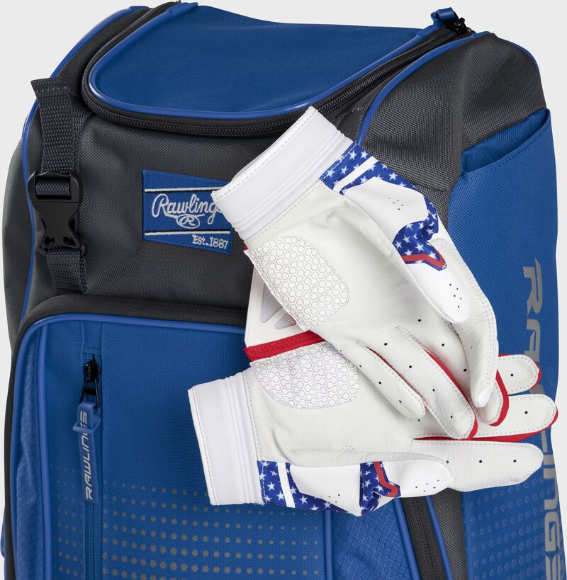 Two batting gloves hanging on the front Velcro strap of a Franchise baseball backpack - SKU: FRANBP-R