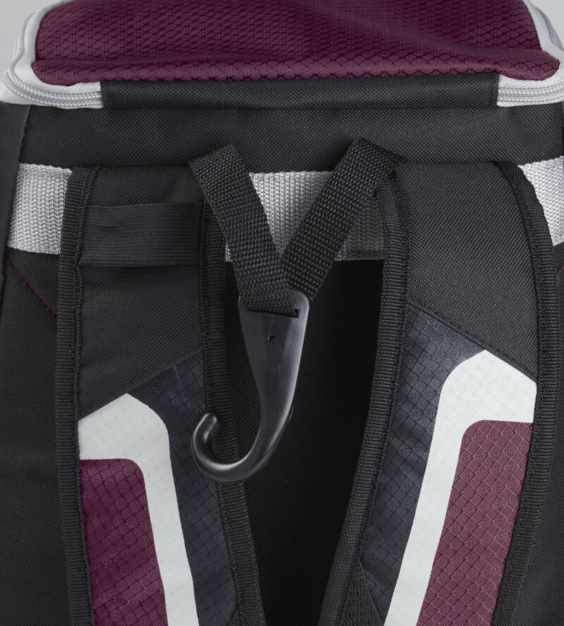 Exterior handle on the back of a black/maroon R500 backpack with a hook for hanging it up