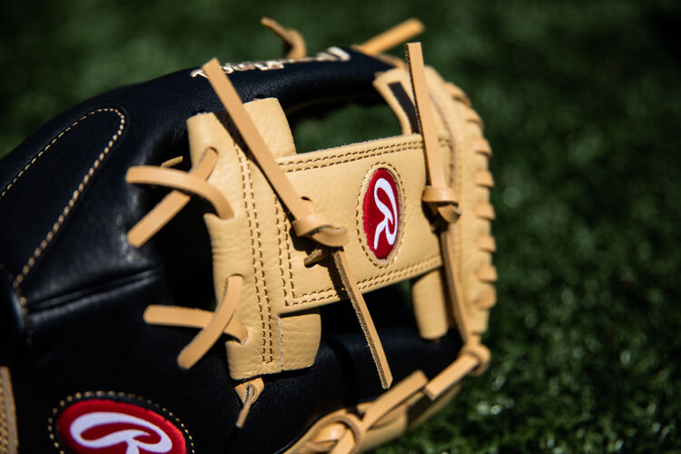 Camel I-web on a Rawlings Prodigy infield glove lying on a field - SKU: P115CBI