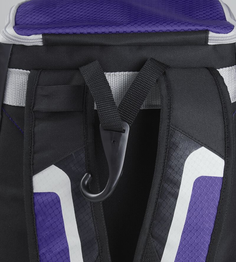 Exterior handle on the back of a black/purple R500 backpack with a hook for hanging it up