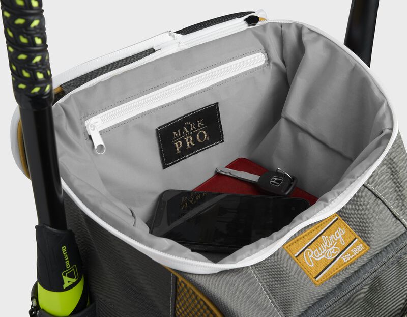 Top compartment of a light gold Impulse bag with a phone, keys and black "The Mark of a Pro" patch - SKU: IMPSLE-LG
