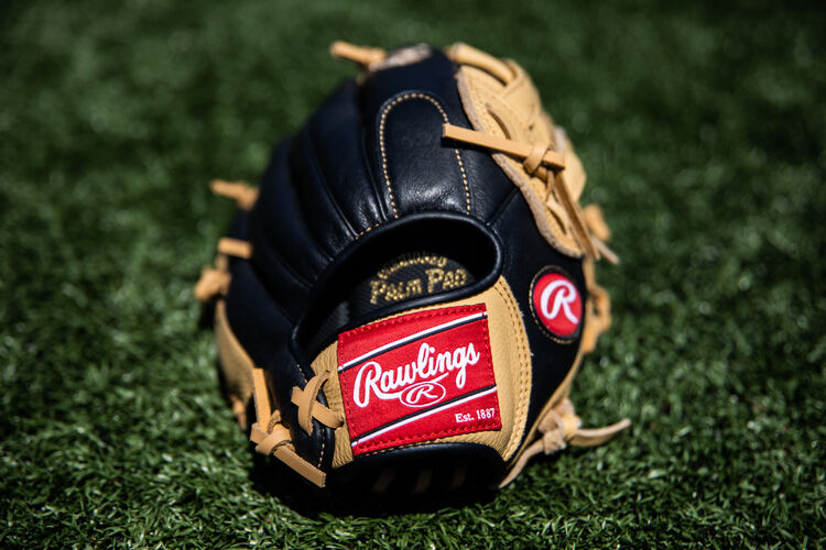 Rawlings patch on a Rawlings Prodigy 12-Inch glove lying on a field - SKU: P120CBH
