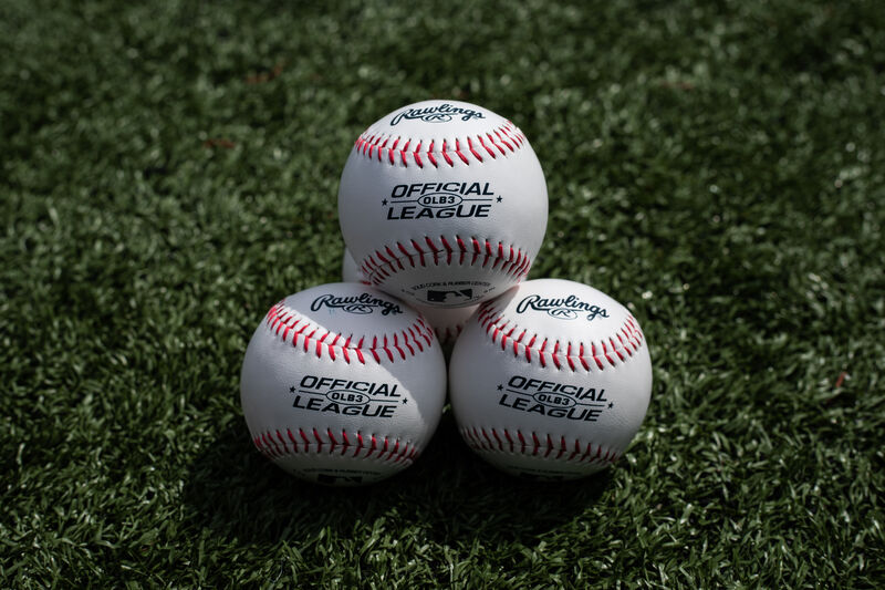 Three Rawlings baseball lying together in a triangle on a field - SKU: OLB3