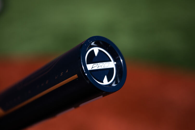 Navy end cap of a Quatro Pro -9 fastpitch bat with a field in the background - SKU: FPZP9