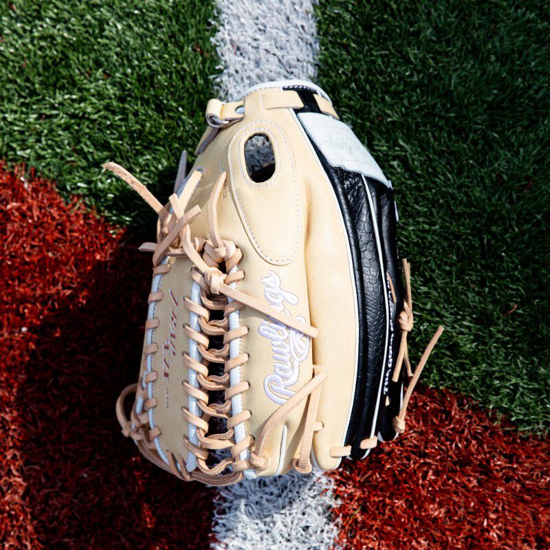 A Heart of the Hide ColorSync 8.0 outfield glove on a field