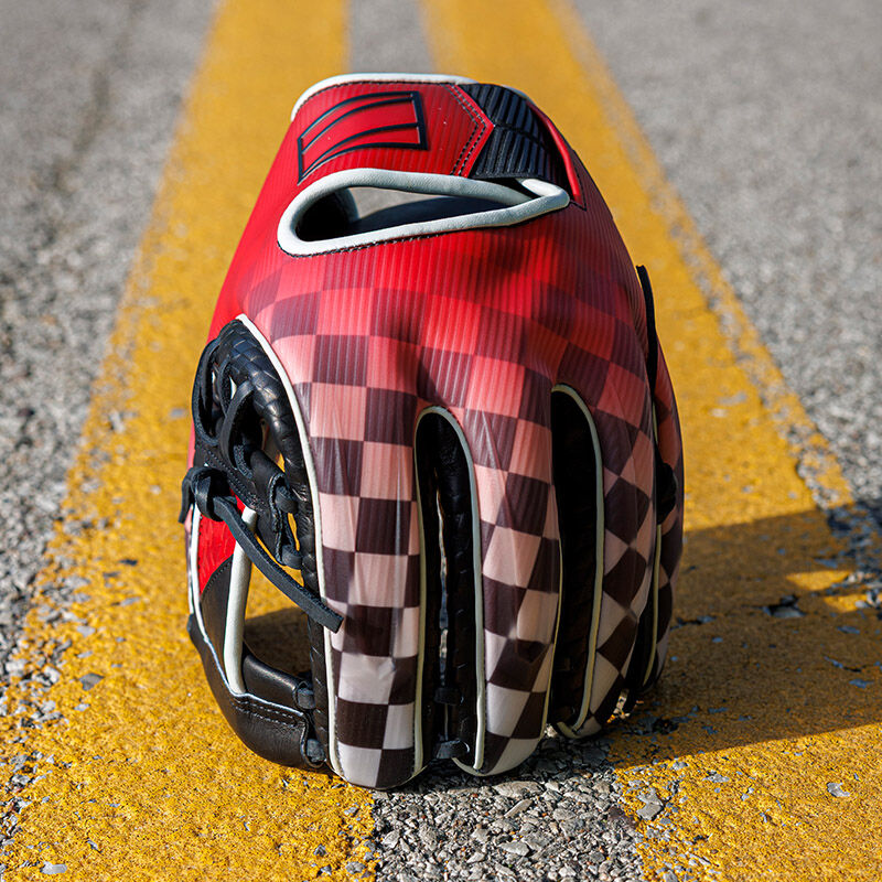 Picture of a REV1X Checkered Flag infield glove standing on its fingertips on the yellow lines of a road