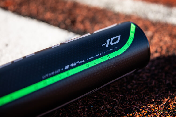 Barrel of a -10 5150 USSSA bat laying next to home plate on a field - SKU: UT1510