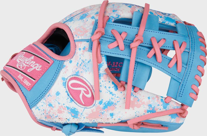 Thumb of an exclusive Heart of the Hide splatter print infield glove with a Columbia blue/pink split laced single post web
