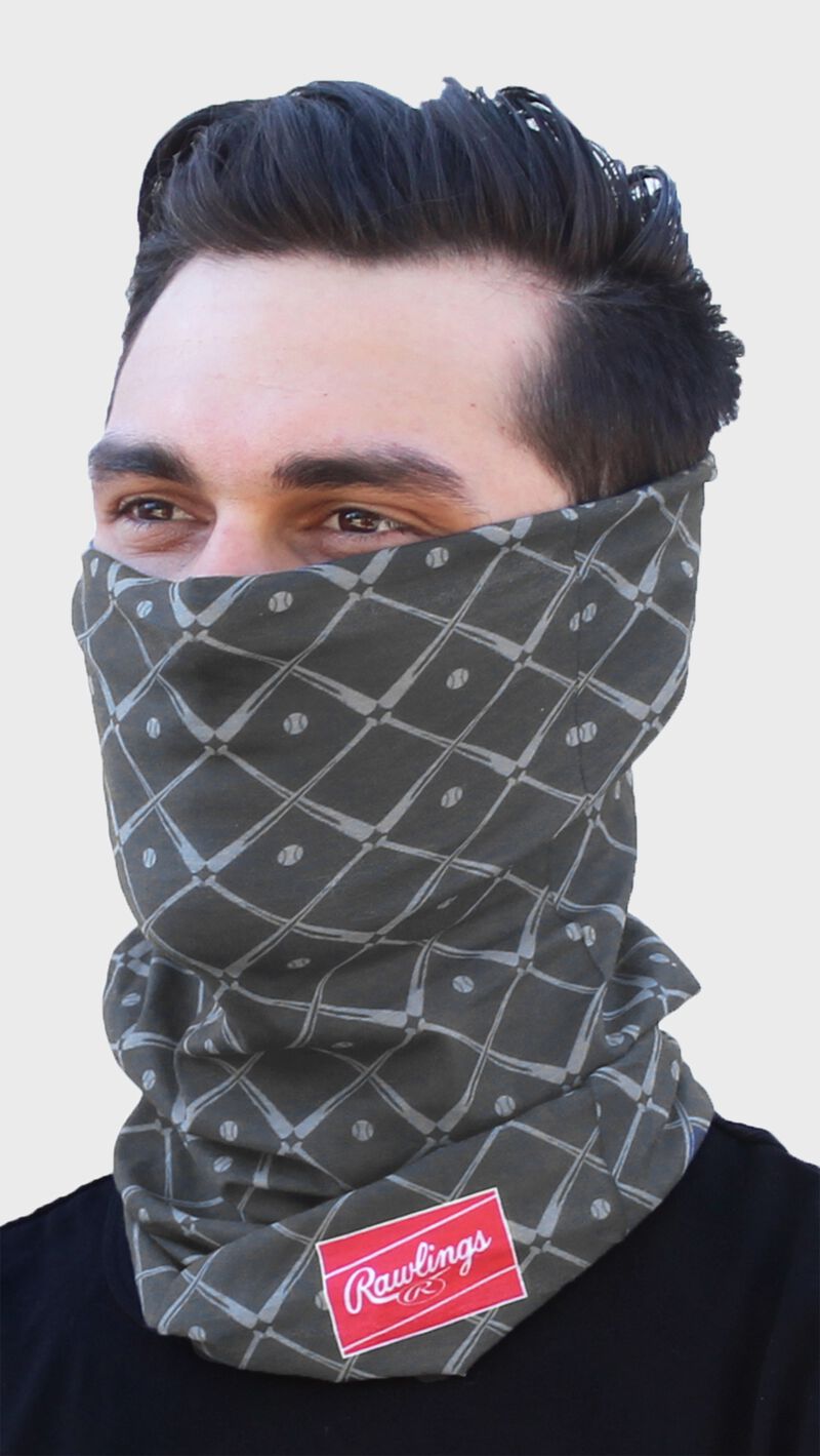 A guy wearing a graphite Rawlings adult multi-functional head and face cover around his mouth and nose - SKU: RC40005-005