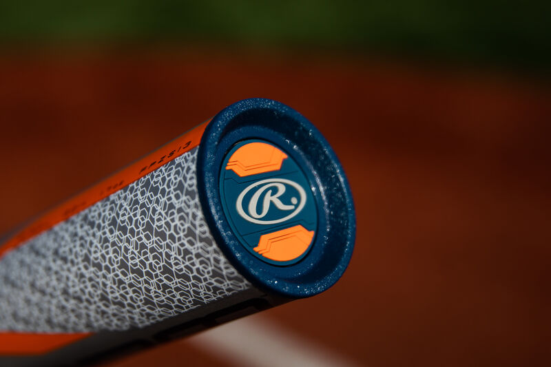 A navy blue end cap on a 2020 Storm Fastpitch softball bat with a field in the background - SKU: FPZS13