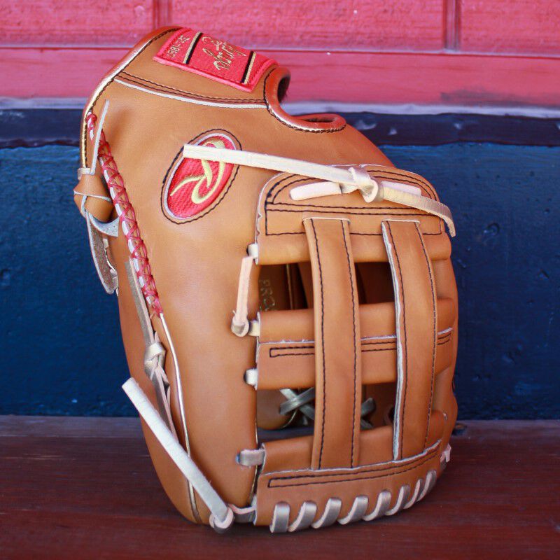 A Heart of the Hide Sierra Romero glove standing up on a bench in a dugout - SKU: PROSR32