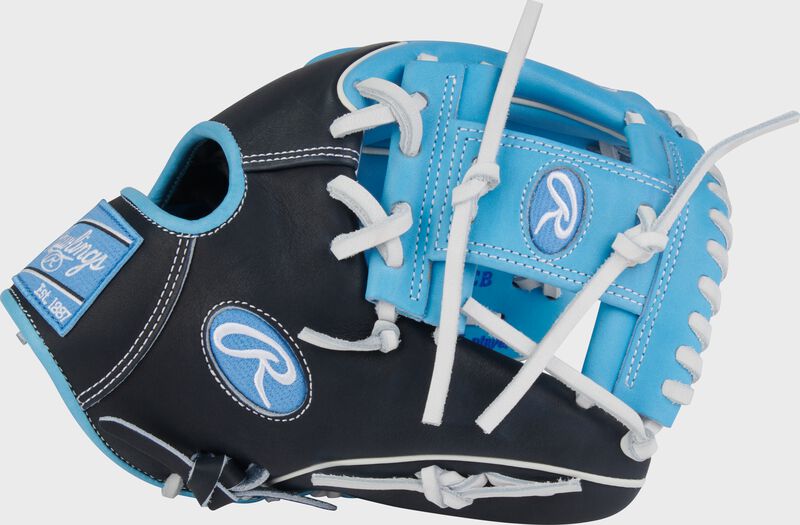 Black thumb of a Rawlings Heart of the Hide 11.75-Inch Wing Tip Infield Glove with a Columbia blue Pro I-web