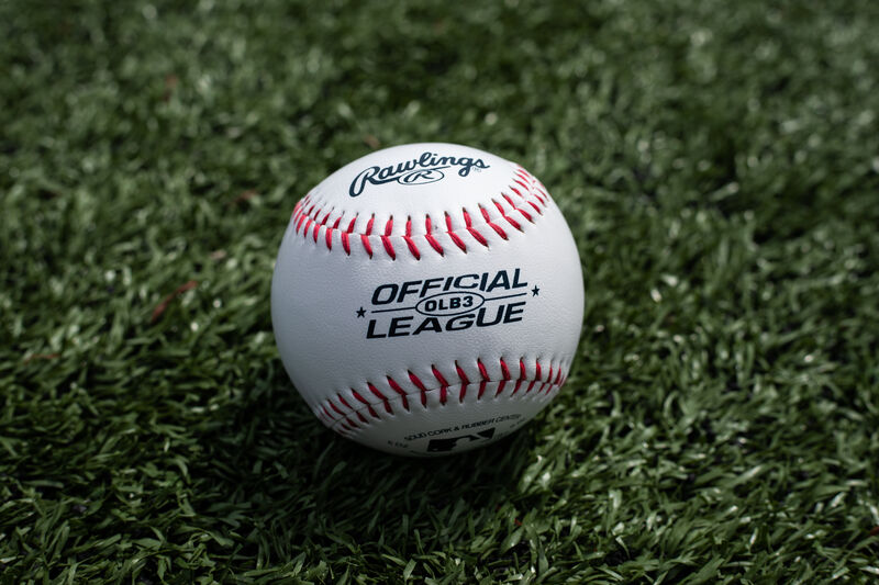 A Rawlings Official League recreational ball lying on a field - SKU: OLB3