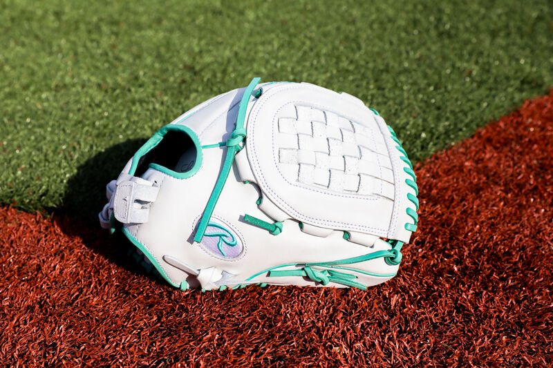 A white Liberty Advanced Color Series 12-inch Basket web glove with mint laces on a field - SKU: RLA120-3WM