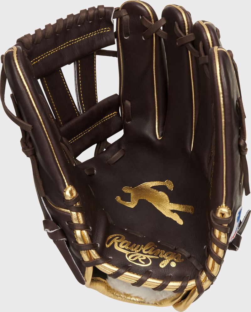 Palm of a Rawlings G57 Manny Machado glove with a mocha palm and gold stamp of Machado's logo - SKU: PROSNP7-MM13