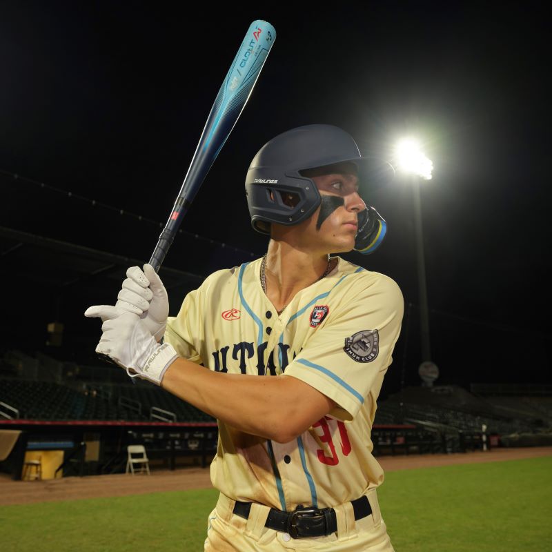 A player in his batting stance with a blue Clout AI bat