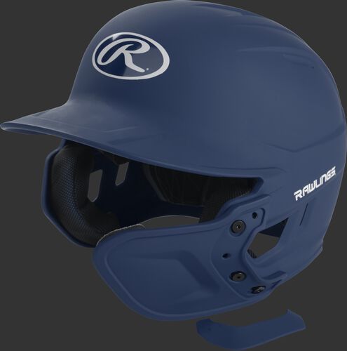A navy MEXTR attached to a Mach batting helmet with the removable TPU piece off to show the hardware