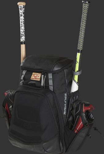 Front left of a black R1000 Gold Glove equipment bag filled with cleats and bats in the side compartments