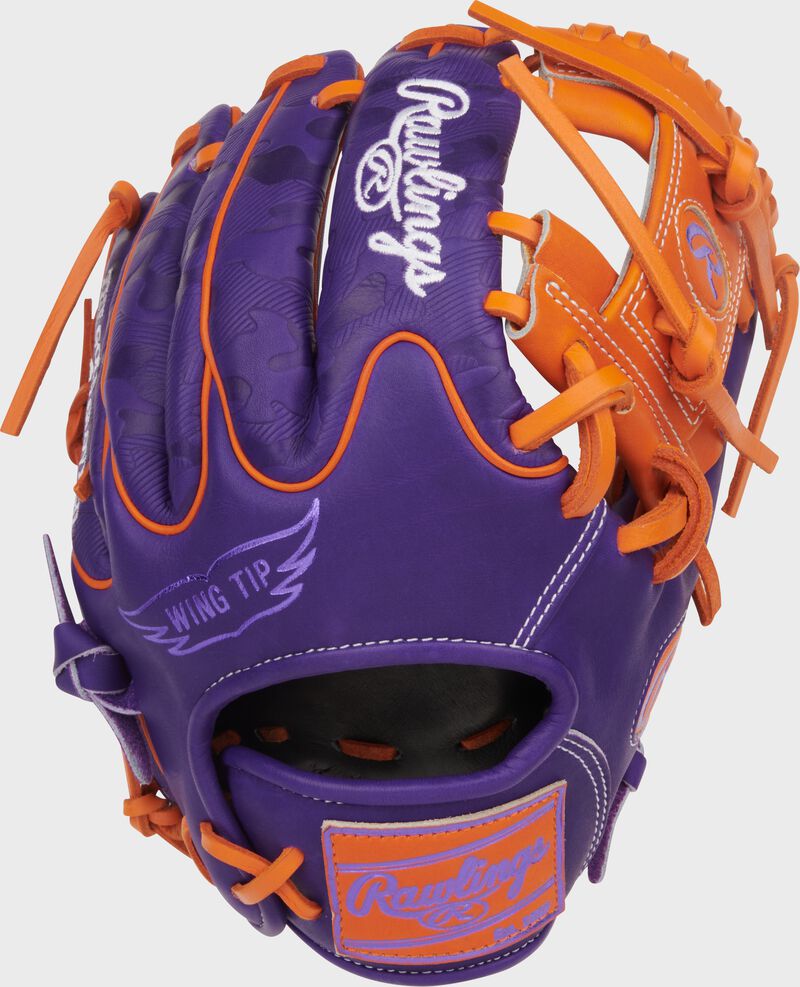 Purple Wing Tip back of a Heart of the Hide ContoUR Fit 11.5-Inch Wing Tip Glove with an orange leather Rawlings patch