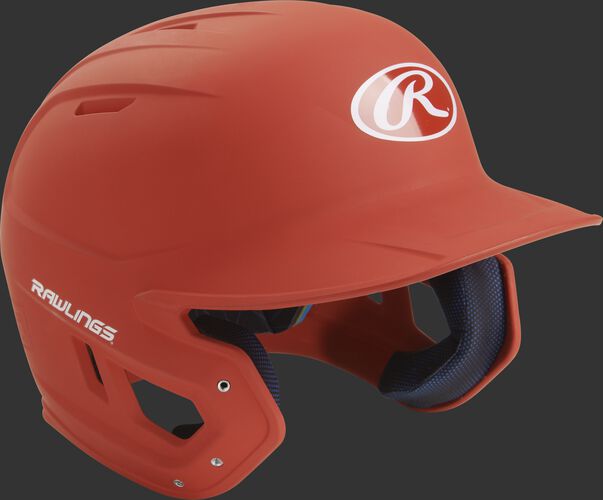 Right angle view of a matte MACH batting helmet with a burnt orange shell