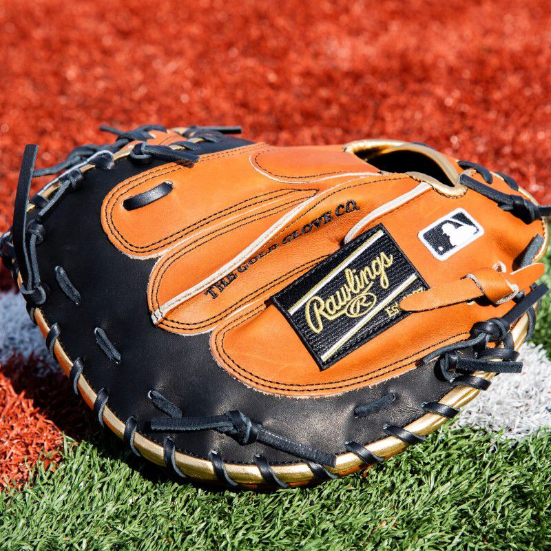 Back fingers of a gold brown ColorSync 8.0 Heart of the Hide glove on a field