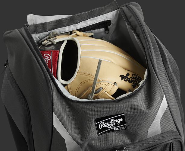 A glove in the dedicated glove storage pocket of a Rawlings Legion equipment backpack - SKU: LEGION-GR