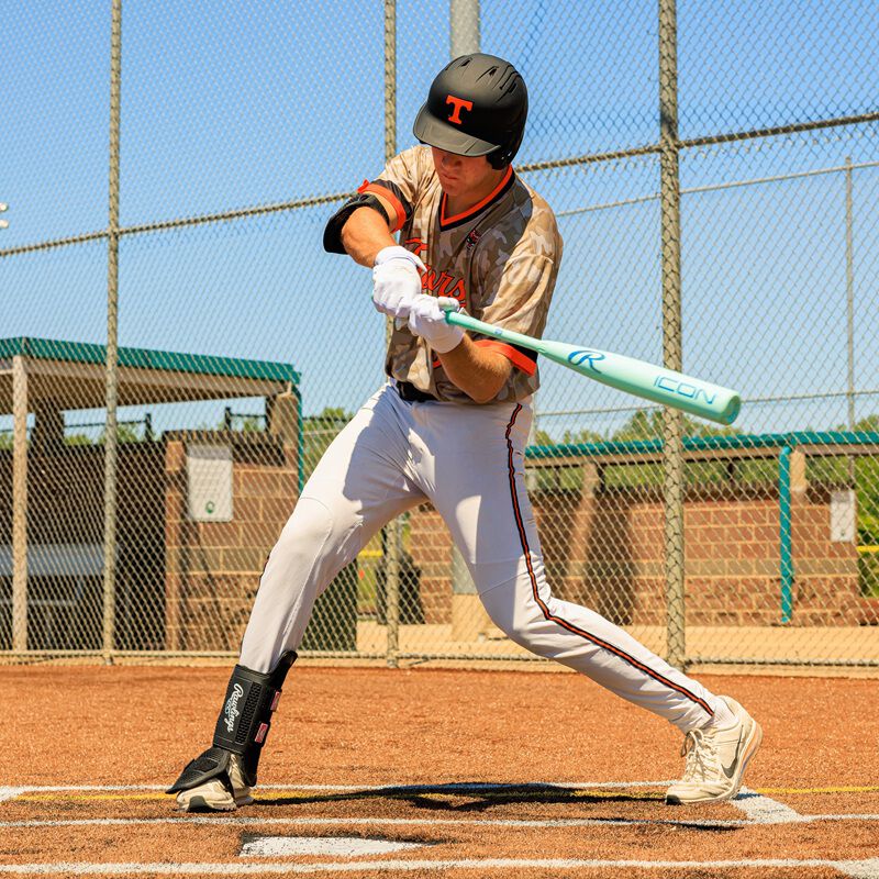 A player swinging a 2026 Rawlings Icon BBCOR bat loading=
