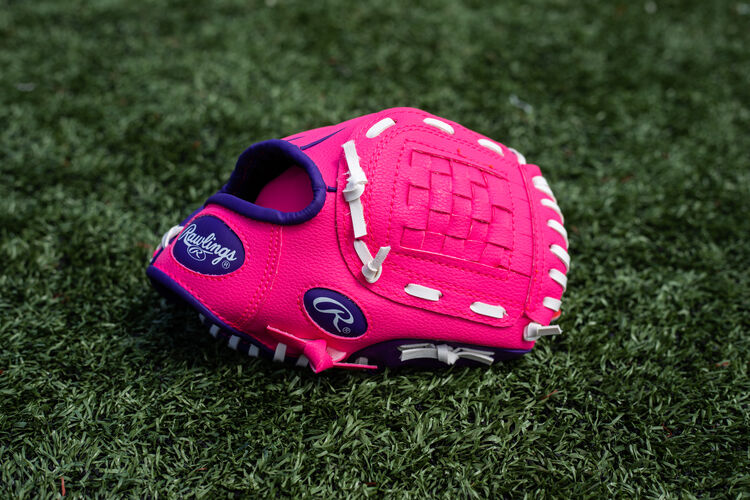A pink/purple Players Series youth Basket Web glove lying on a field - SKU: PL91PP