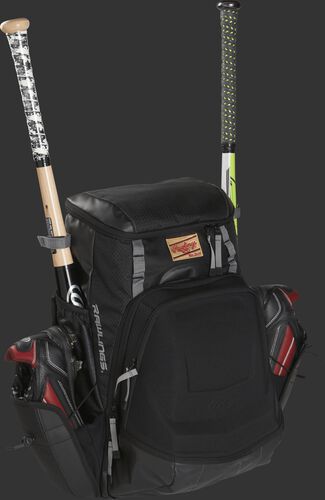 Front right of a black R1000 Gold Glove Series baseball backpack with two bats and cleats