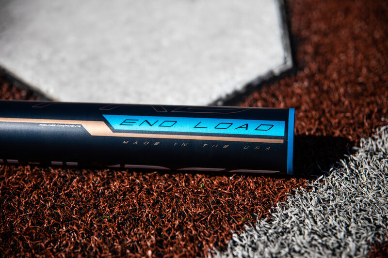The barrel of a softball Quatro Pro end-loaded bat lying next to home plate - SKU: FPPE10