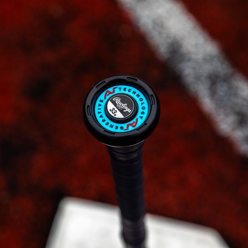 Blue knob of a Rawlings Clout AI BBCOR bat with a field in the background