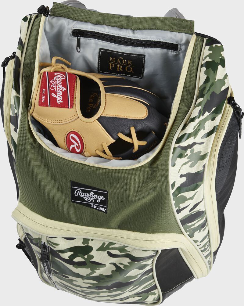 A glove in the dedicated glove storage pocket of a Rawlings Legion equipment backpack - SKU: LEGION-CAMO