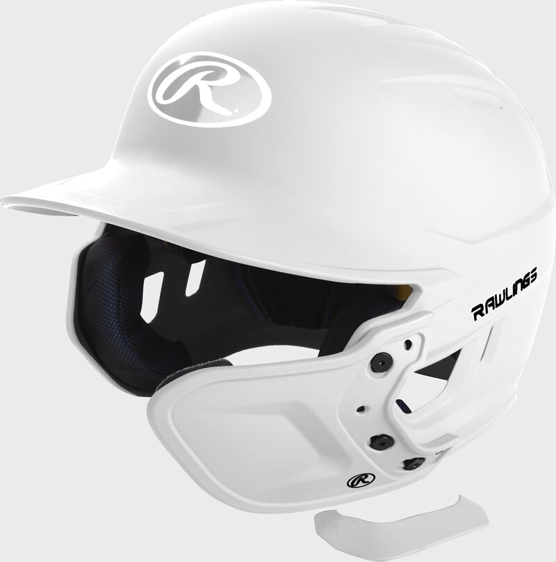 A matte white MEXT attached to a Mach batting helmet showing the hardware