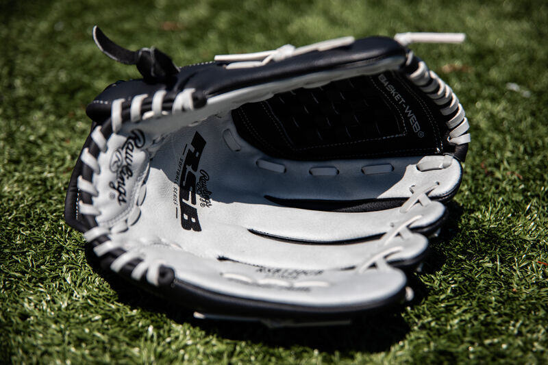 Grey palm of a Rawlings RSB Series recreational glove lying in the grass on a field - SKU: RSB120GB