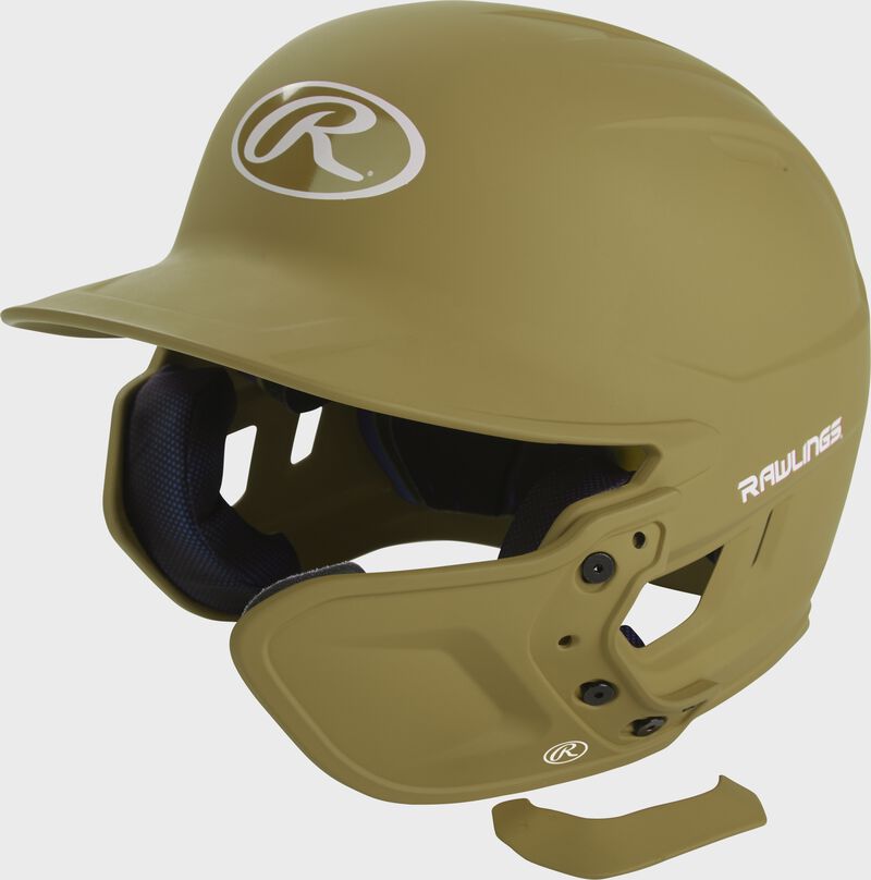 A matte Vegas gold MEXT attached to a Mach batting helmet showing the hardware